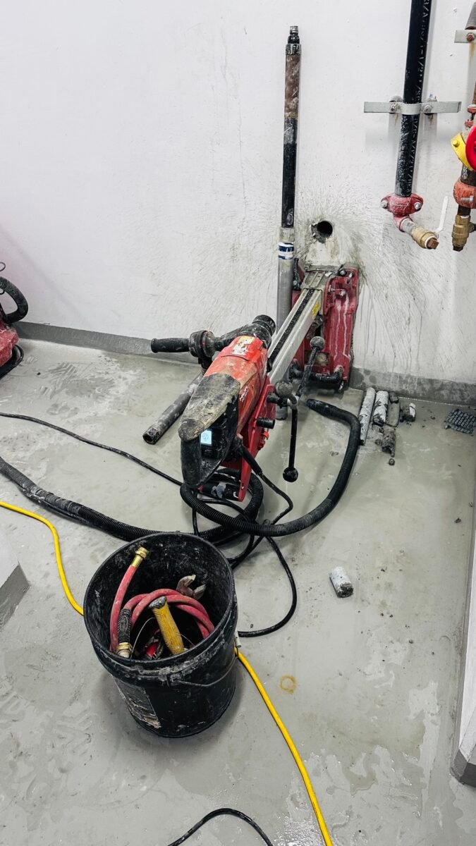 Indoor diamond core drilling for a pipe penetration through a concrete wall, Vancouver BC