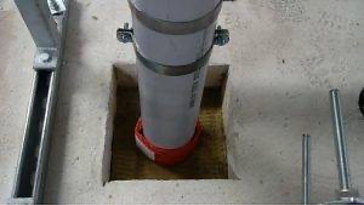 Before fire stopping: pipe penetration with firestop collar in concrete slab